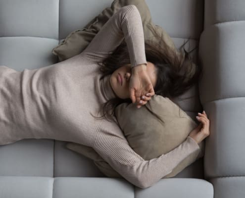 Peaceful Girl Lying On Back On Comfortable Couch At Home