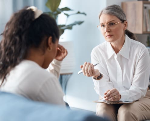 Shot Of A Mature Psychologist Sitting With Her Patient And Asking Questions During A Consultation